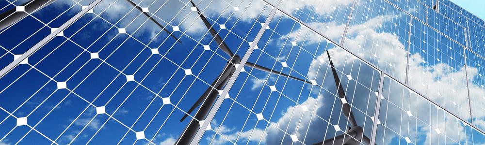 Wind turbines reflected in solar panels.
