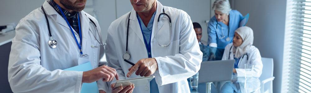 Two doctors pouring over a document.
