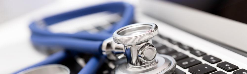 A stephoscope on a computer keyboard.