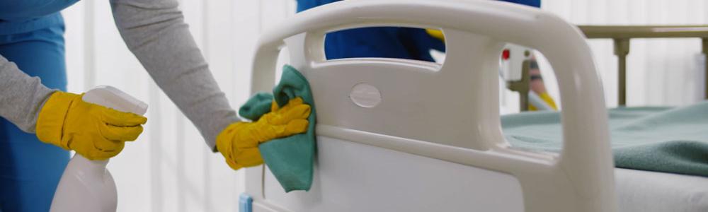 Staff cleaning hospital bed