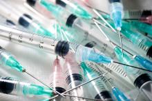 A close up on a pile of medical needles. They are all empty.