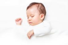 Baby sleeping on white background.