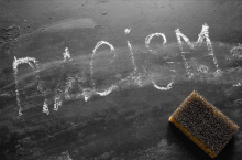 Racism written on a blackboard and rubbed out.