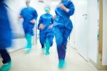 Surgeons running to help a patient in a hospital