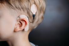 Young boy with cochlear implant