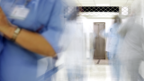 Blurry hospital staff in a corridor