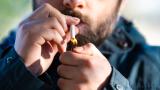 A man lights a cigarette. The camera is directly facing him, and his eyes are just out of the frame.