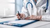 A doctor signing a medical document.