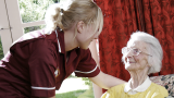 A carer looking after a patient