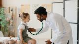 Doctor examines little girl.