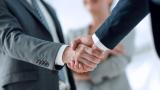 Business professionals shake hands