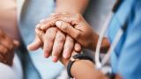 Nurse holding patient's hands
