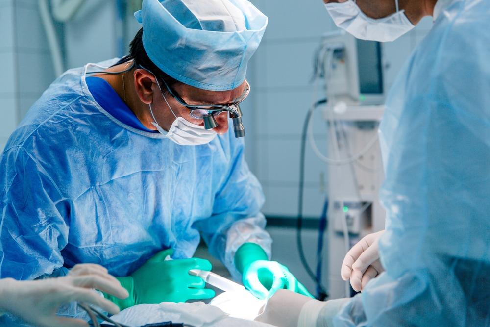 A surgeon operates on a person.
