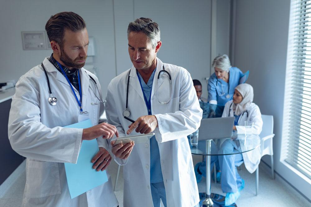 Two doctors pouring over a document.