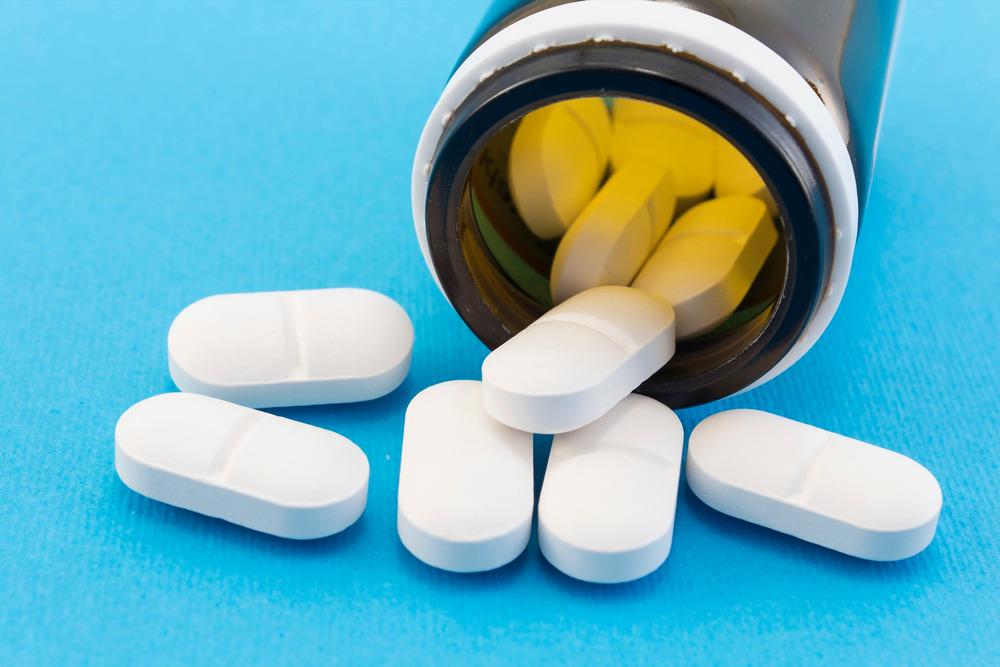 Antibiotic pills on a blue background.