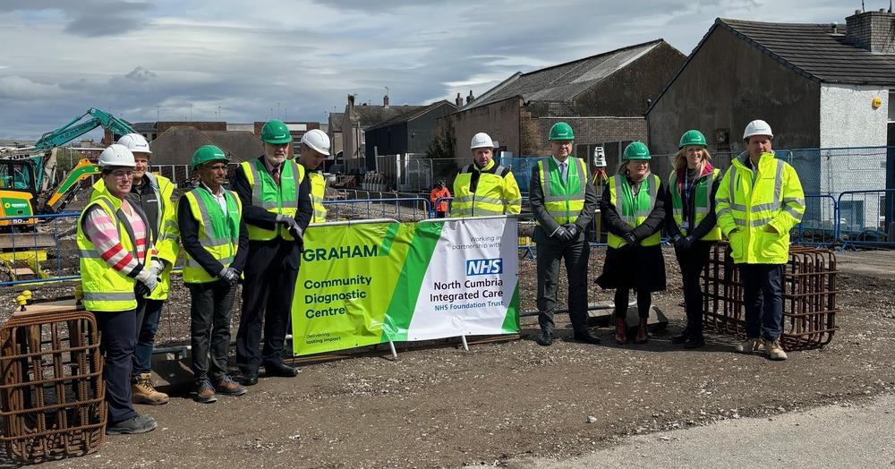 A group of builders working on the Centre in high vis coats.