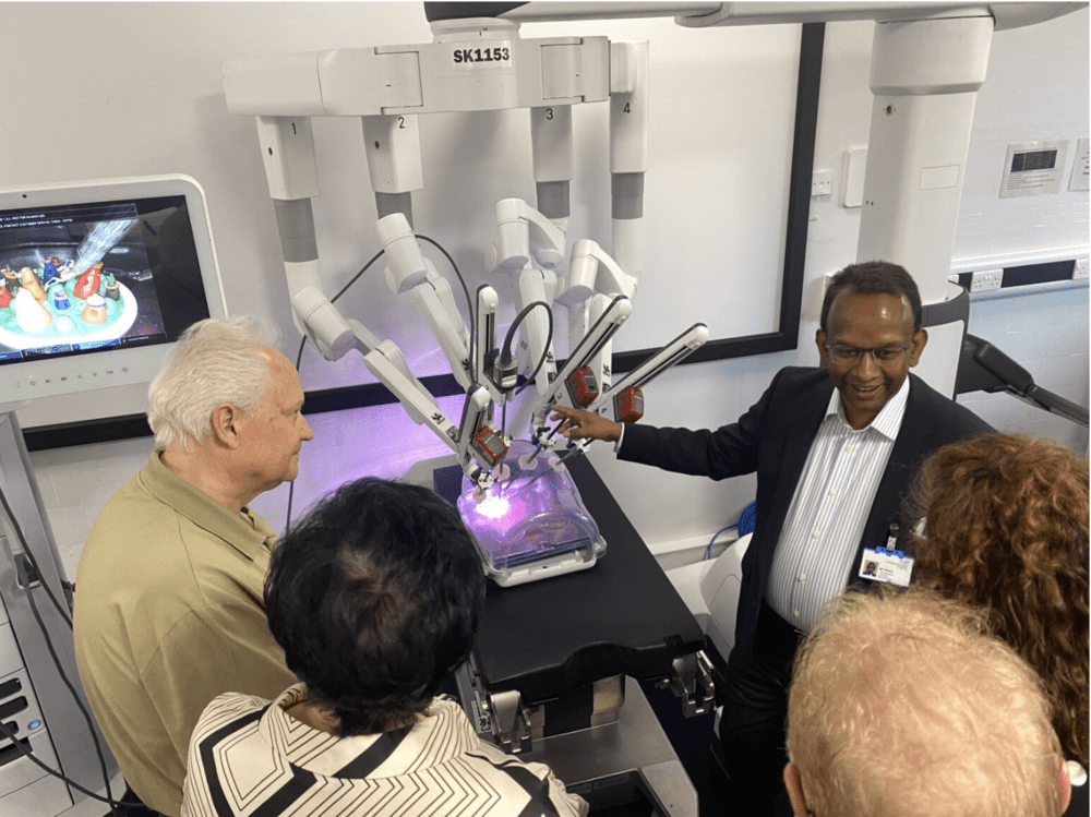 A man demonstrates the capabilities of a robotic arm.