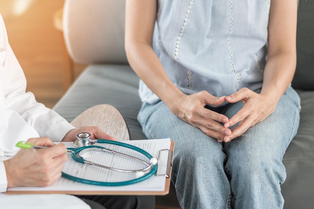A woman being consulted by a doctor.
