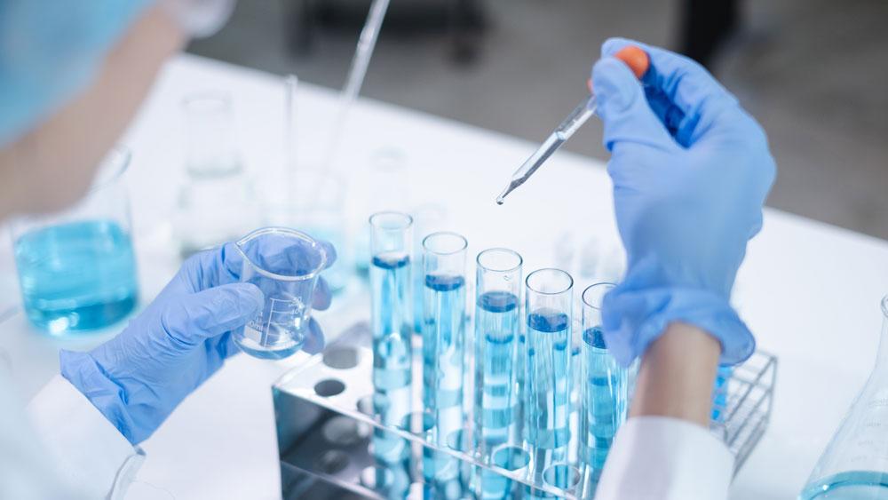 Scientist in lab with test tubes