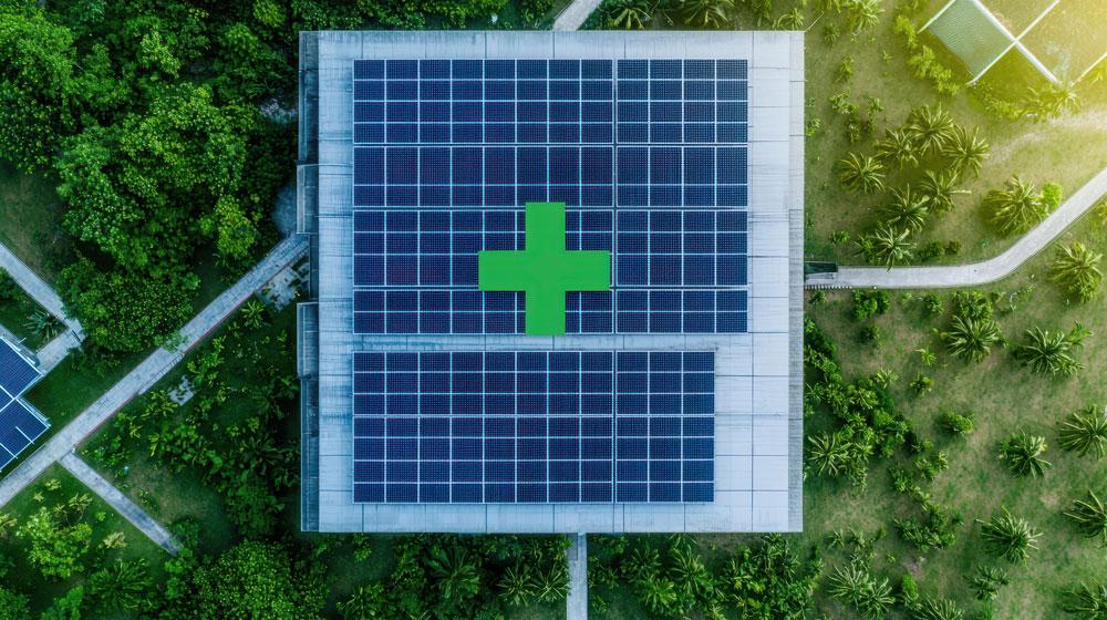 Aerial view of building with solar panels and medical cross