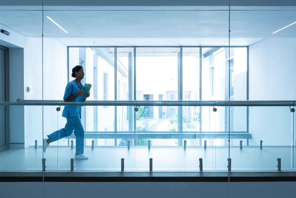 doctor running through hospital corridor