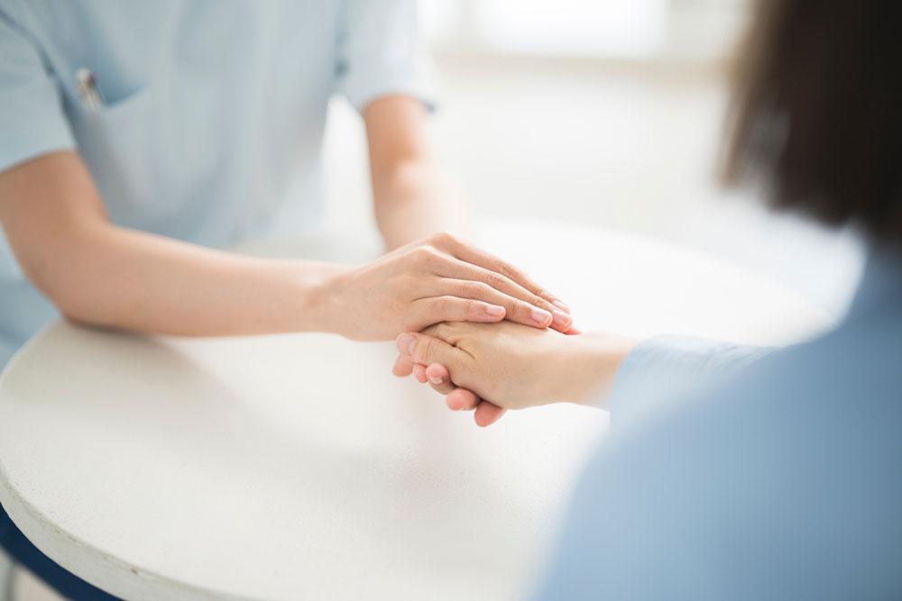 Two people holding hands