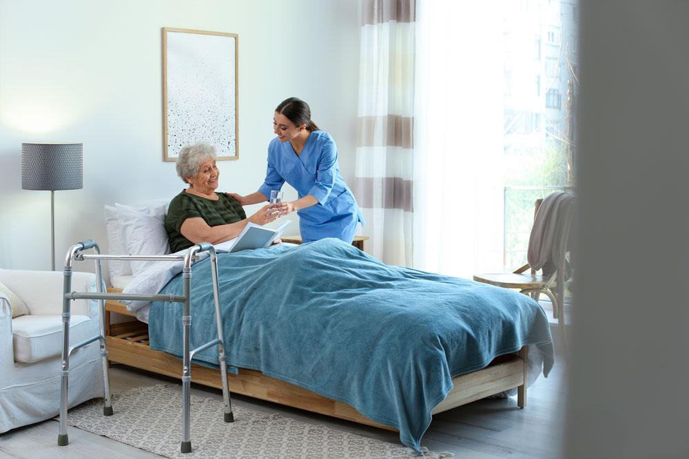 Nurse looking after woman in hospice